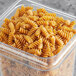 A container of Barilla whole grain rotini pasta on a table.