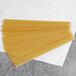 A pile of Barilla Linguine Fini pasta on a white surface.