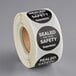 A roll of TamperSafe black paper tamper-evident drink labels with sealable safety labels.