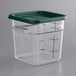 A clear square polycarbonate container with a green lid.