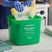 A green Noble King-Pail 8 quart detergent pail being used with a yellow sponge and soapy water.
