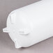 A white plastic cylinder with a screw-on top and holes.