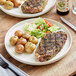 A plate of steak and potatoes seasoned with Backyard Pro All-Purpose Seasoning.