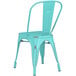 A Lancaster Table & Seating distressed seafoam metal outdoor cafe chair with a metal back.