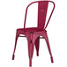A red metal Lancaster Table & Seating outdoor cafe chair with a seat and back.