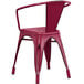 A red metal Lancaster Table & Seating outdoor arm chair with a back and armrests.