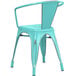A Lancaster Table & Seating distressed seafoam metal arm chair.
