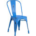 A Lancaster Table & Seating blue metal outdoor cafe chair with a black frame.