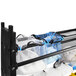 A black metal Mytee modular van shelving system with blue and white mesh bags on a shelf.