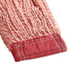 A close up of a red and white knitted fabric with a red thread.