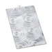 A Menu Solutions Alumitique aluminum clipboard with a swirl design on it.