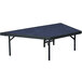 A blue rectangular National Public Seating stage platform with black legs.