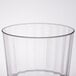 A close up of a WNA Comet clear plastic fluted tumbler with a rim.
