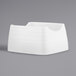 A white melamine sugar packet holder with a curved edge.