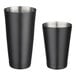 Two black stainless steel tumblers with lids.