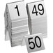 A stack of Choice stainless steel number table tents with numbers 1 to 50 on metal stands.