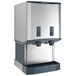 A white Scotsman countertop ice machine and water dispenser with two water dispensers, one silver and one black.