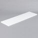 A white rectangular Avantco cutting board.