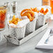 A Tablecraft lattice stainless steel snack set with fried onion rings in it on a table.