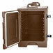 A brown plastic Carlisle Cateraide front loading food pan carrier with an open door.