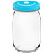 An Acopa clear glass drinking jar with a blue lid.