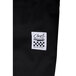 A close up of black Chef Revival chef pants with a logo in white.