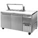 A Continental Refrigerator stainless steel sandwich prep table with 2 doors open on top of a counter.
