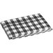 A folded black and white plaid tablecloth with a black flannel back.