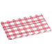 A red and white checkered table cover with a textured gingham pattern on a table.