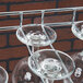 A Regency chrome wire bar glass rack holding wine glasses.