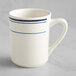 An Acopa ivory stoneware cup with blue bands on the handle.