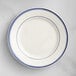 An Acopa ivory stoneware plate with blue bands on the rim.