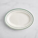 An Acopa ivory stoneware platter with green lines on it.