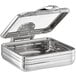 An Acopa stainless steel chafing dish with a glass lid on a counter.