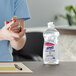 A close-up of a person's hands using Purell hand sanitizer.