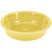 A yellow Fiesta china bowl on a white surface.