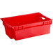A red plastic agricultural crate with handles.