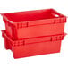 A red plastic agricultural crate with handles.