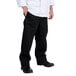 A man wearing Chef Revival black baggy chef pants and a white shirt.