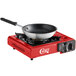 A red Choice portable stove with a pan on top.