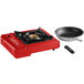 A red Choice portable gas stove with a frying pan and a pot on it.