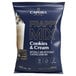 A blue bag of Capora Cookies & Cream Frappe Mix with text and a picture of a drink mix.
