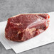 A piece of raw Warrington Farm Meats Coulotte Steak on white paper.