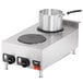 A silver pot on a Vollrath countertop electric hot plate.