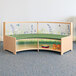 A Whitney Brothers wooden curved bench with a green cushion and flower design.