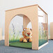 A stuffed lion toy sitting in a Whitney Brothers wood play house cube.