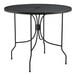 A black Lancaster Table & Seating outdoor table with a round top.