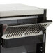 A close up of an APW Wyott conveyor toaster with a metal rack.