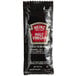 A black Heinz malt vinegar packet with a red label.