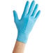 A hand wearing a blue Noble NexGen disposable glove.